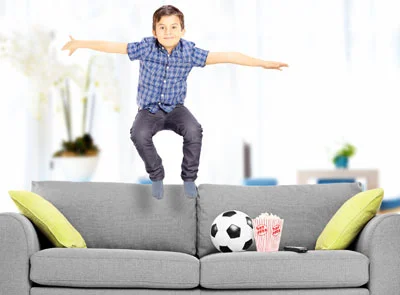 Child jumping on couch